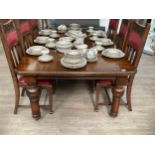 An oak extending dining table on canon leg supports, one extra leaf and winder, 177cm extended,