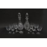A set of six port and sherry glasses with bamboo detail and two decanters including crystal