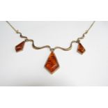 A 9ct gold necklace with amber drops hung on wavy links, 46cm long, 7g