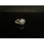 A 9ct white gold floral ring set with diamond chips. Size K, 2.1g