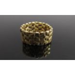 A gold articulated woven ring. Size R/S, 8.5g