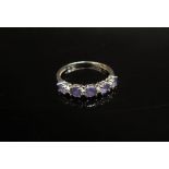 A 9ct white gold half hoop tanzanite and diamond ring. Size S, 2.2g