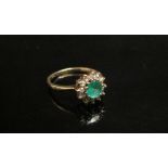 A 9ct gold emerald and diamond daisy ring. Size M/N, 1.7g