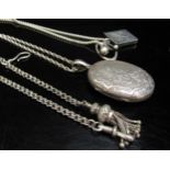 A Victorian engraved oval locket hung on silver chain, a silver stamp case on chain and a