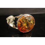 A bangle set with a large oval amber stamped 925