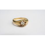 An 18ct gold ring with small central diamond in open claw mount. Size U/V, 4.3g