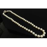 A single strand of pearls with gold pearl set clasp stamped 9ct, 46cm long