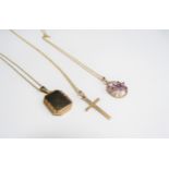 Three 9ct gold pendants including diamond and amethyst floral, engraved cross and locket all hung on