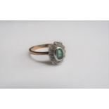 A 9ct gold emerald and diamond cluster ring. Size P, 2.6g
