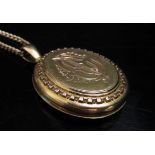 An 9ct gold chain, 62cm long, 11.6g with an unmarked gold Victorian oval locket, 11.1g (22.7g