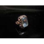 A gold ring set with a rectangular aquamarine, shank stamped 333. Size F, 3.3g