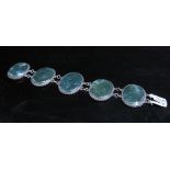 A silver bracelet with five oval moss agate panels, 16cm long