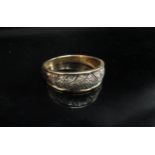 An 18ct gold ring with chevron design set with diamond chips. Size X/Y, 4.2g