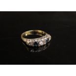 An 18ct gold diamond and sapphire ring. Size K/L, 2.6g