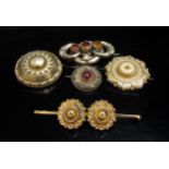 A gold brooch stamped 9ct, three memoriam brooches and another