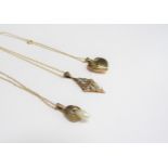 Three 9ct gold pendants including diamond set, heart shaped locket and pearl drop, all hung on