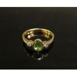 A 9ct gold peridot and diamond chip ring. Size L/M, 1.9g