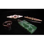 A gold brooch stamped 9ct, carved jade pendant, gold ring stamped 9ct and a costume brooch