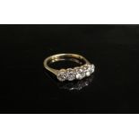 A five stone graduated diamond ring, stamped 18ct. Size S, 3.1g