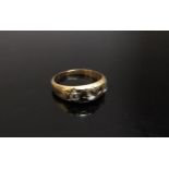 A gold ring set with three old cut diamonds in star settings, unmarked. Size K, 3.2g