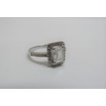 A white gold ring the centre emerald cut diamond 1.54ct set in a halo of diamonds with diamond set
