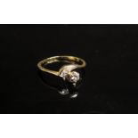 A gold crossover ring with single diamond and diamond chips, unmarked. Size K/L, 1.8g
