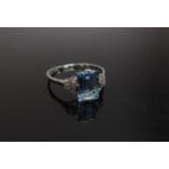 A white gold aquamarine and diamond ring, the central aquamarine 9mm x 6mm flanked by five