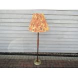 A Danish Teak and brassed metal standard lamp with fluted shade. Approx 145cm high including shade