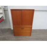 A Ladderax wooden sliding door cabinet with glass shelf plus a drop leaf cabinet with two metal