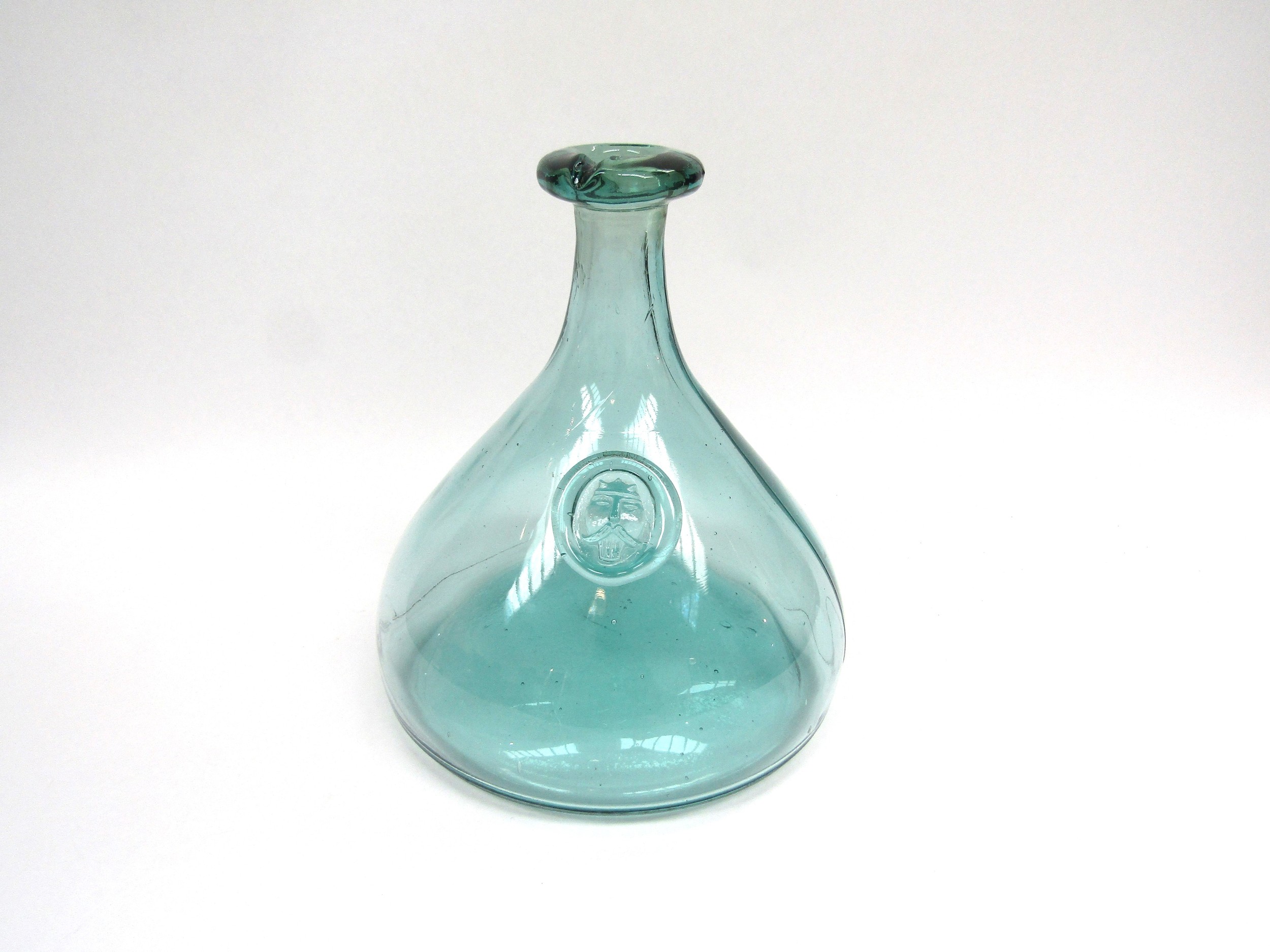A Holmegaard blue glass carafe by Ole Winther with an applied "Viking" seal. 23cm high