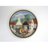 A Bornholm of Sweden ceramic dish with relief moulded village scene with figures, hand-painted. 23.
