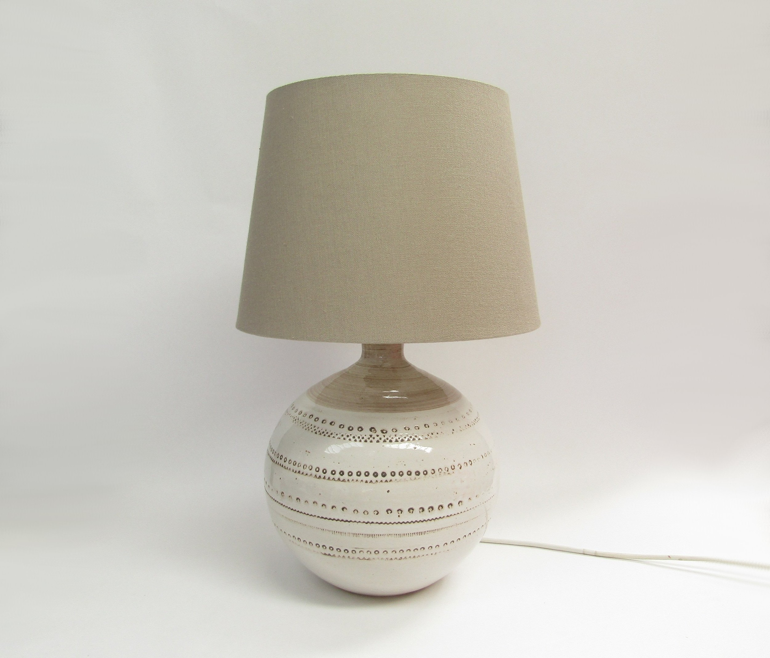 A Bitossi lamp base in white with impressed motifs (possibly made for Pier UK) with shade. Base 30cm