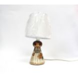 A Jersey Pottery table lamp "Girl holding flower" design. Base 13cm high, overall height 30cm