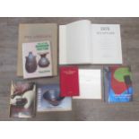 A collection of art books and catalogues including Erte sculpture, Studio pottery, Patrick Hughes,