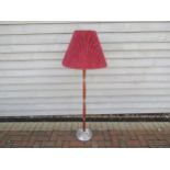 A Danish hardwood and Aluminium standard lamp with fluted shade. 146cm high including shade.