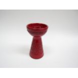 An Italian Bitossi candlestick by Aldo Londi in red glaze, 17.5cm high.