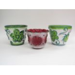 A pair of Italian ceramic planters 1970's in white with green foliate detail and another in red.