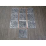 A set of ten mid 20th Century white metal wall tiles, three set in a frame, the others loose, all