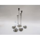 A group of stainless steel candle holders, Danish. Tallest 36.5cm, Together with soda syphon in