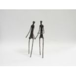 An Alberto Giacometti style metal sculpture of two figures, 26cm high