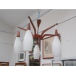 A teak "spider" five branch ceiling light fitting with white glass shades