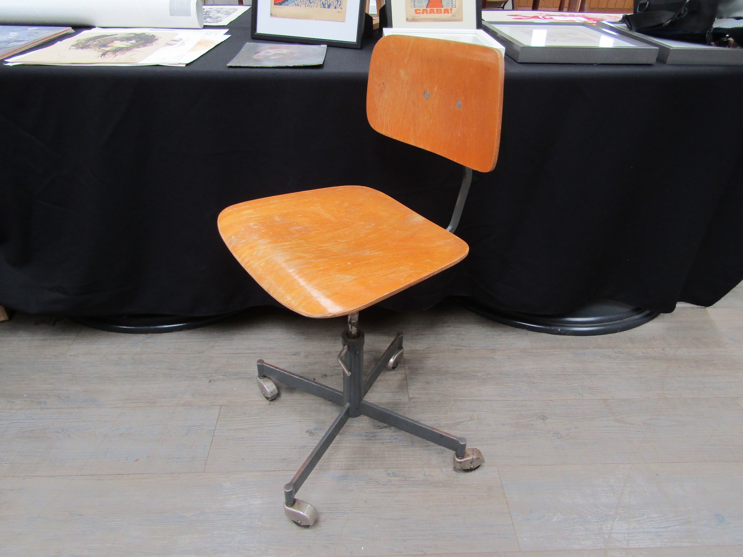 An industrial style beech ply and metal swivel chair