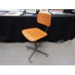 An industrial style beech ply and metal swivel chair