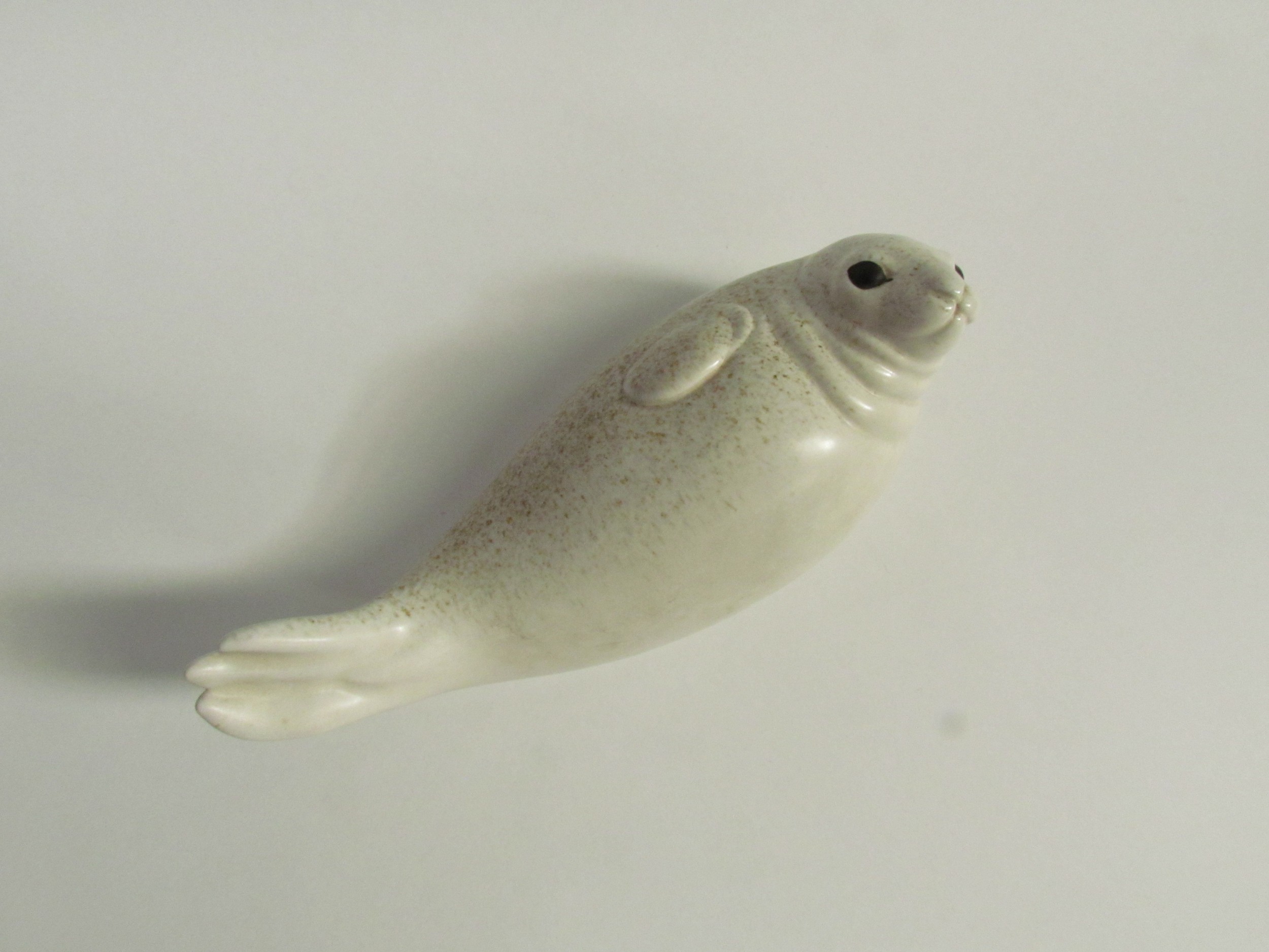 Paul Hoff for Gustavsberg - A ceramic figure of a Seal. Impressed marks to base. 9cm high x 24cm