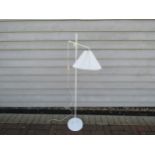 A Danish standard lamp in white with adjustable arm and fluted shade