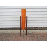 A 1960's orange fibreglass rocket lamp on three teak legs.