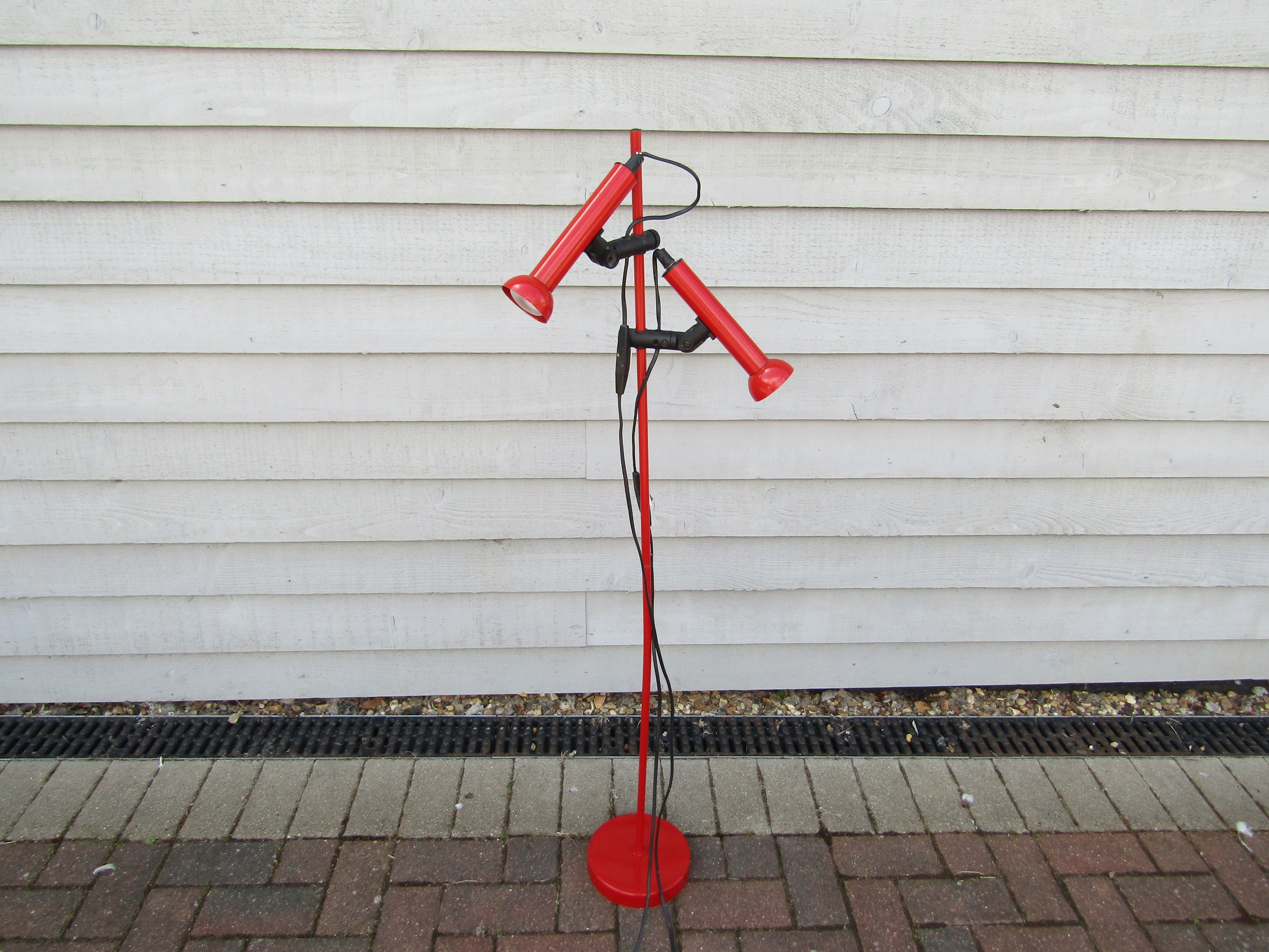A Danish c1980's standard lamp in red with twin adjustable spots.