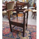 Circa 1820 a pegged oak and fruitwood box seat armchair with hinged seat over square legs joined