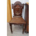 A Victorian oak shield back hall chair with scroll detail, 91cm tall, water damage present