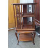 An Edwardian mahogany library swivel bookcase on stand with decorative fret cut panels, satinwood
